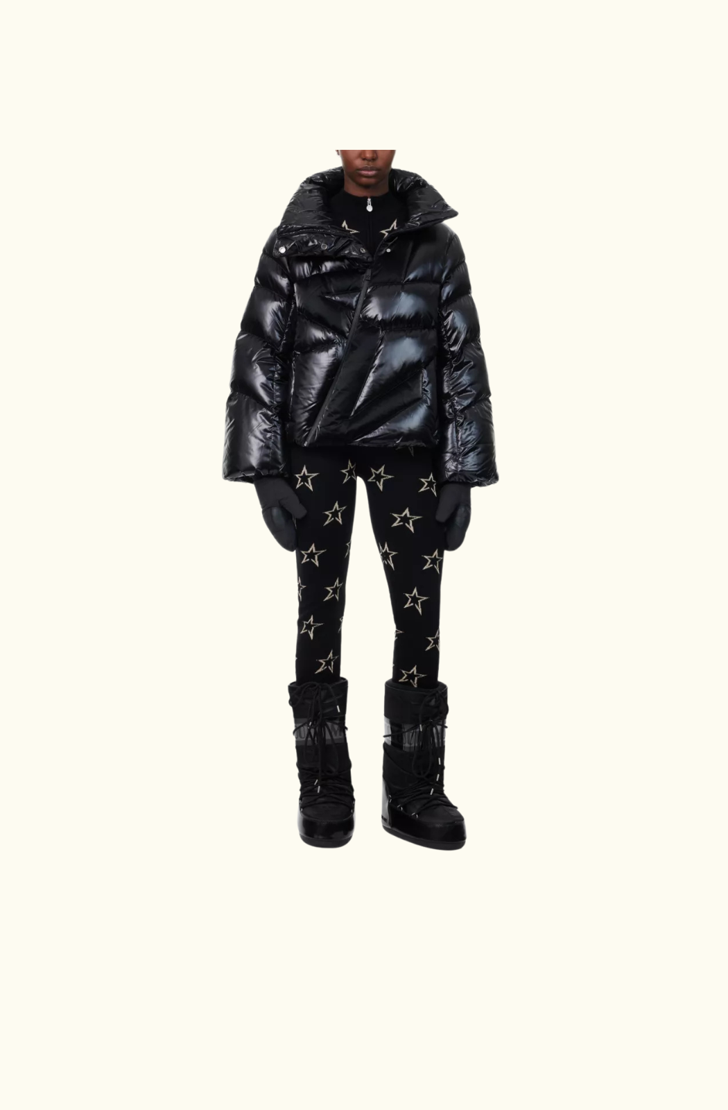 A close-up of the Ariel Down Bomber Jacket in black, showcasing the glossy fabric, dramatic high-neck collar, and asymmetrical zip closure. The quilted down insulation provides warmth while maintaining a sleek, fashion-forward aesthetic.