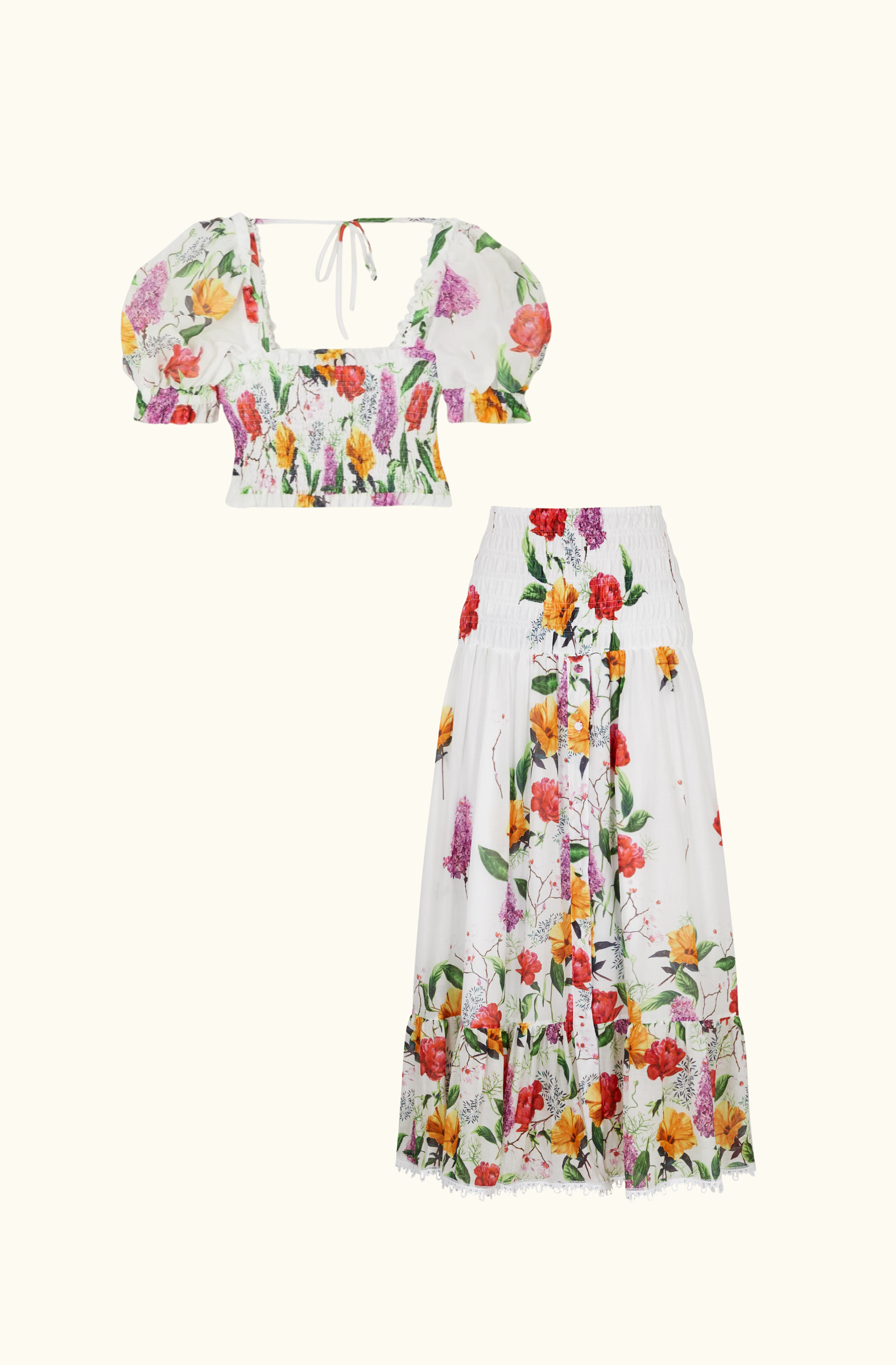 Flat lay of the Charo Ruiz Ibiza matching set featuring a cropped puff-sleeve floral top with a square neckline and a high-waisted floral maxi skirt with smocking and lace hem.