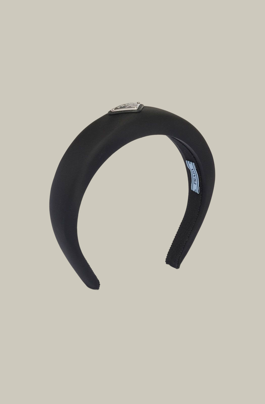 Prada’s black padded Re-nylon headband with triangle logo plaque