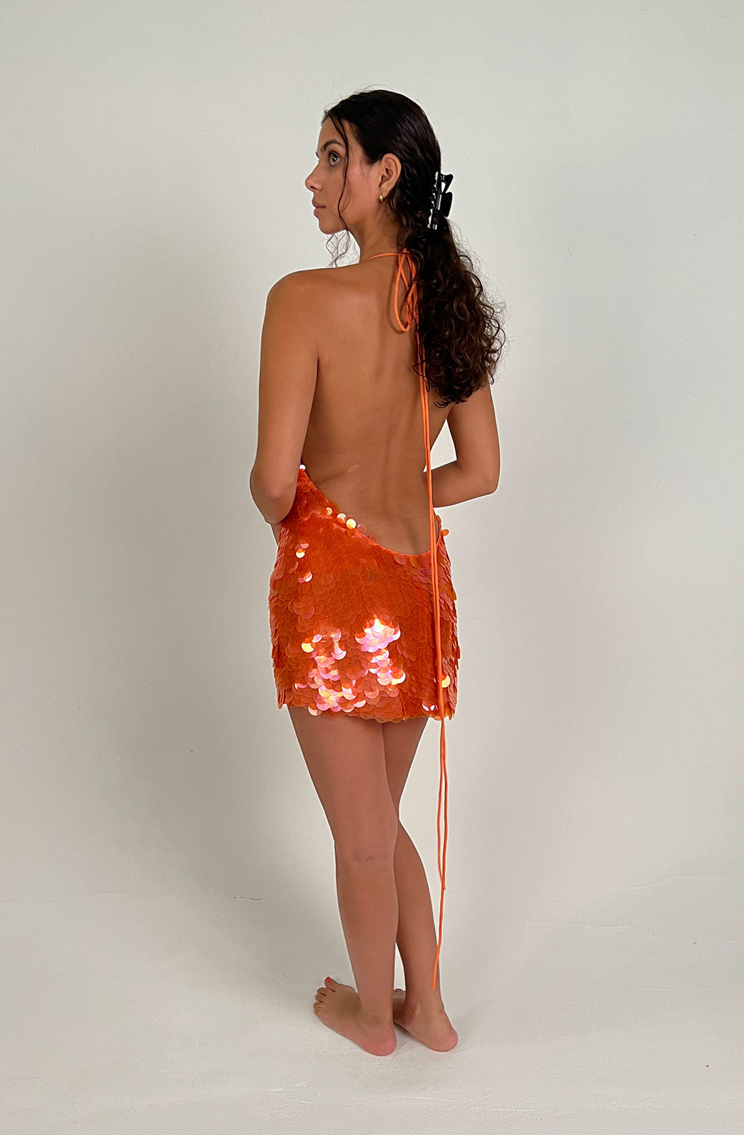 MALIKA DRESS Shimmer and shine wherever you go in Malika, a magic sequin mini that radiates daring decadence, all the better to dance the night away...