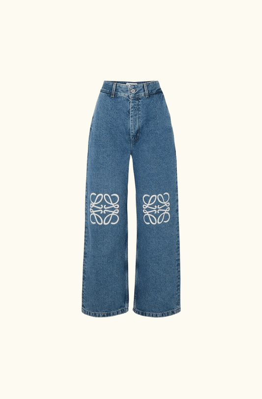 Front view of Loewe Anagram Appliquéd Jeans in classic blue denim. High-rise wide-leg fit with signature white laser-cut Anagram appliqués on both knees