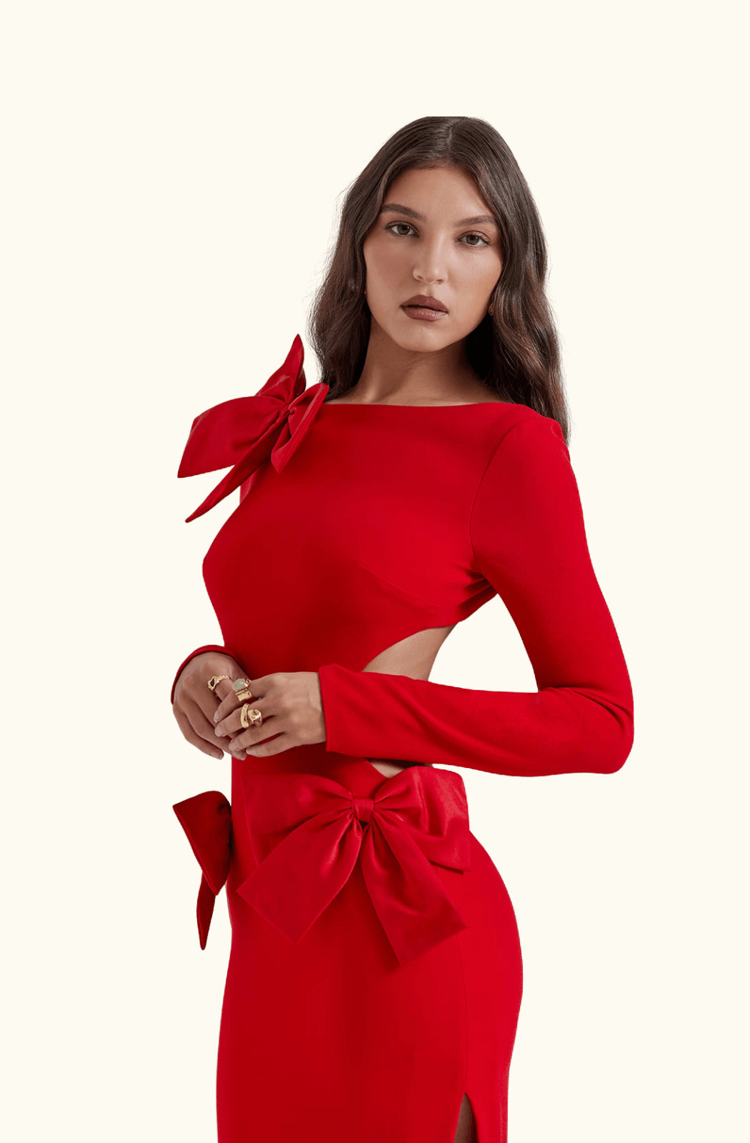 Woman wearing a red dress with bow details on a white background
