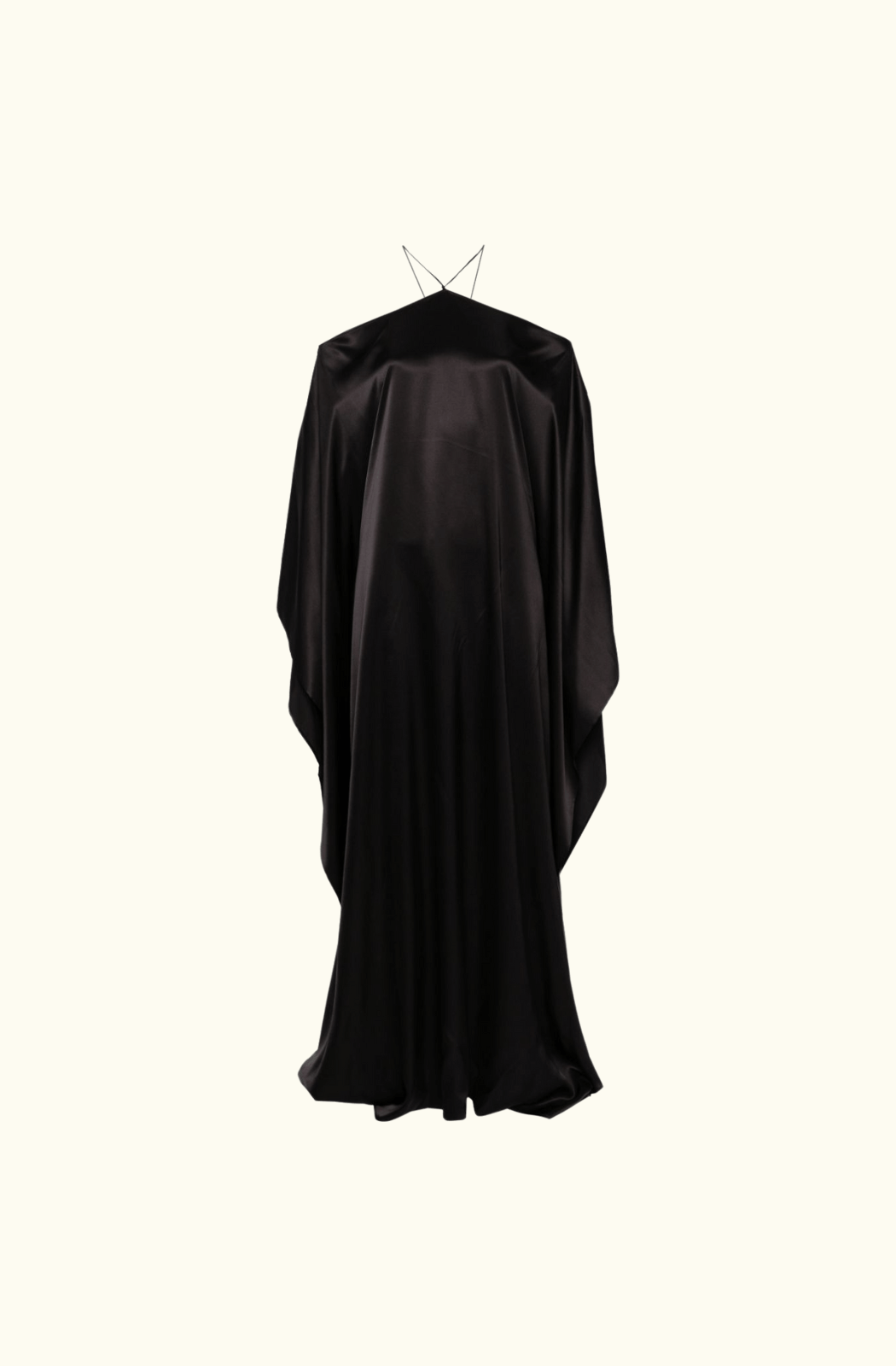 A full front view of the Taller Marmo Sza silk maxi dress, highlighting its luxurious, smooth black silk fabric, halter neckline, and dramatic off-the-shoulder cut with a floor-length hemline.