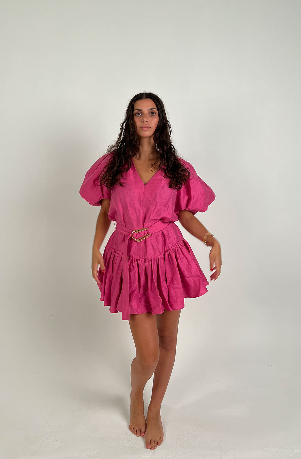 the Wheatland Dress in Flamingo is an elevated look. Crafted from a lush linen blend fabrication, this silhouette features accentuated sleeves, v-neckline, frill toward the hem and elevated d-ring belt with luxe gold hardware.