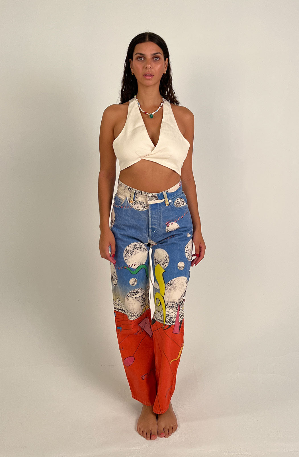 Women's Discoteca Jeans in the all-over multi-coloured discoteca print from the archive. The graphic jeans are high-waisted with a straight leg fit, iconic 5-pocket design, waistband with belt loop and a button and zip fly. Made from hand-crafted, incredibly flattering premium denim. Model front view