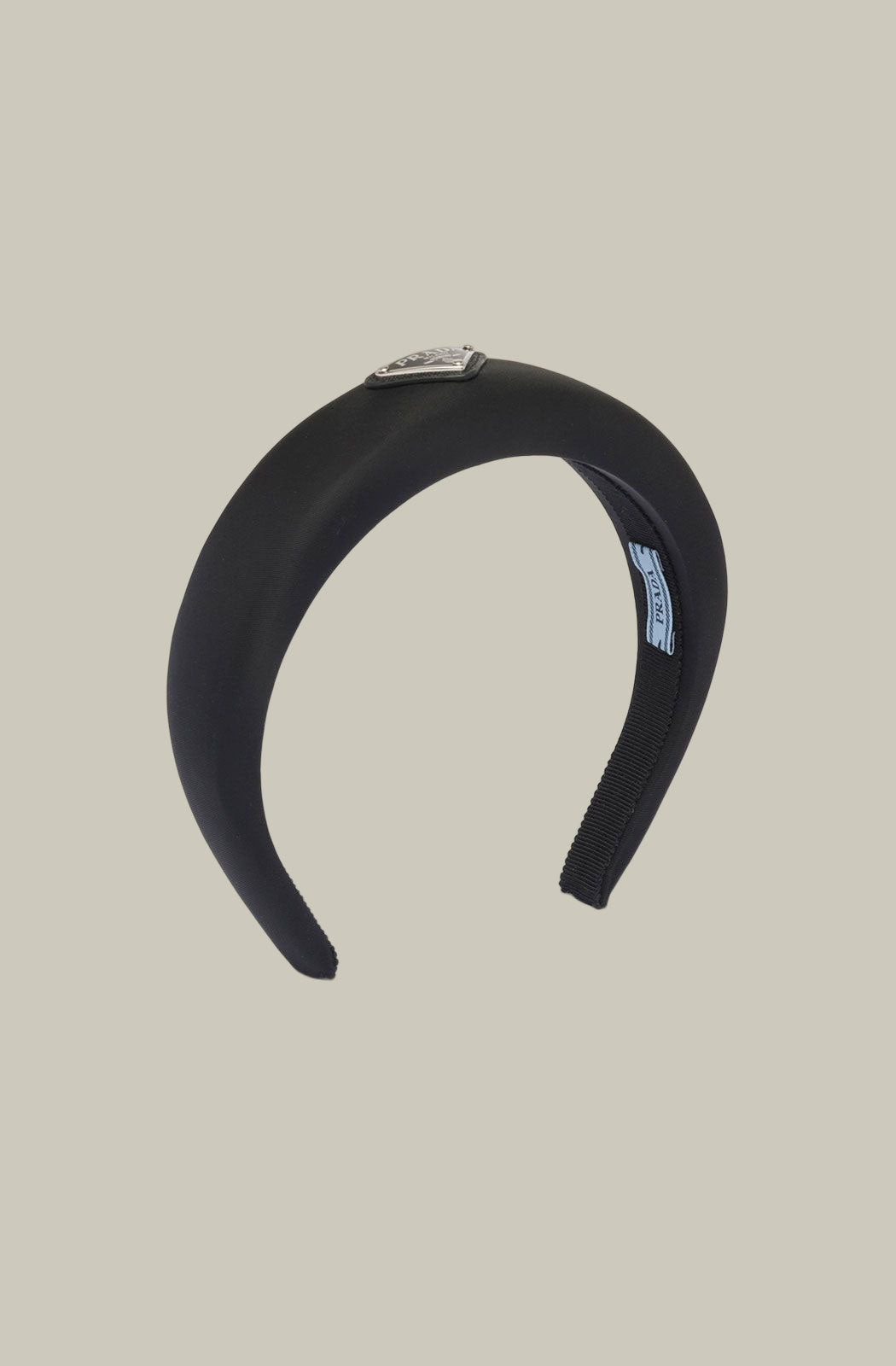  Prada’s black padded Re-nylon headband with triangle logo plaque